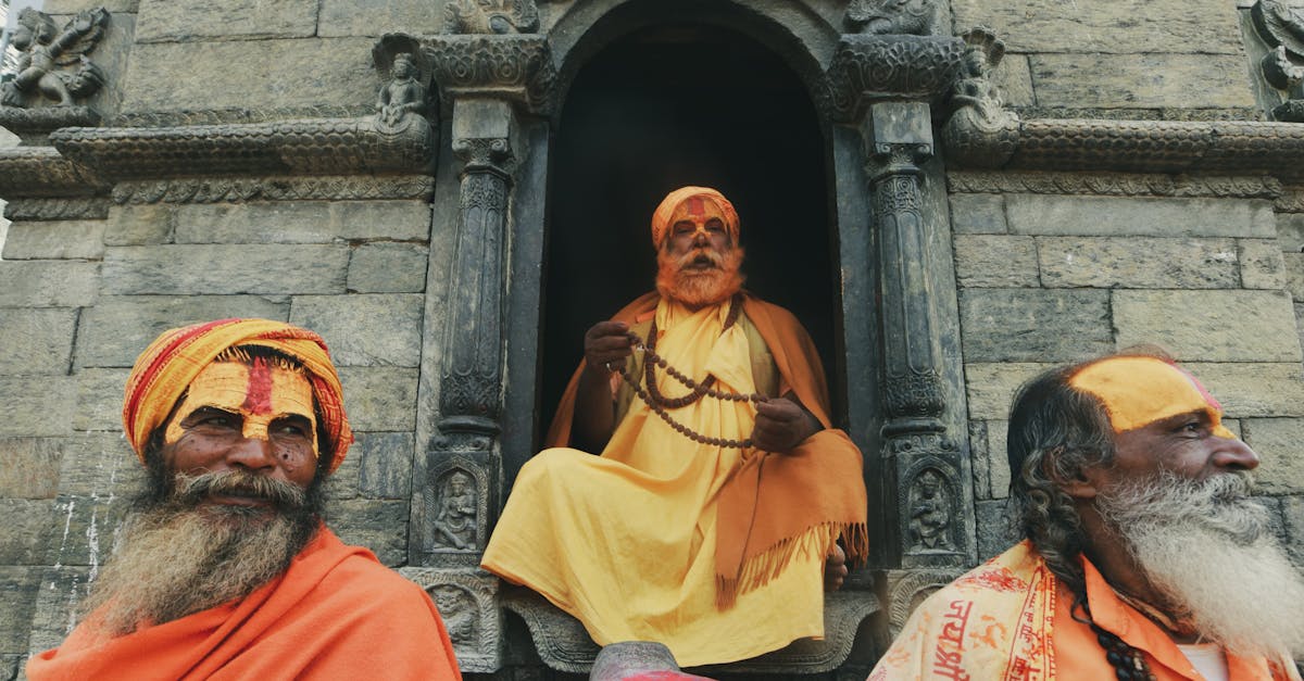 Portrait of three Hindu holy men in vibrant attire at a temple in Nepal.